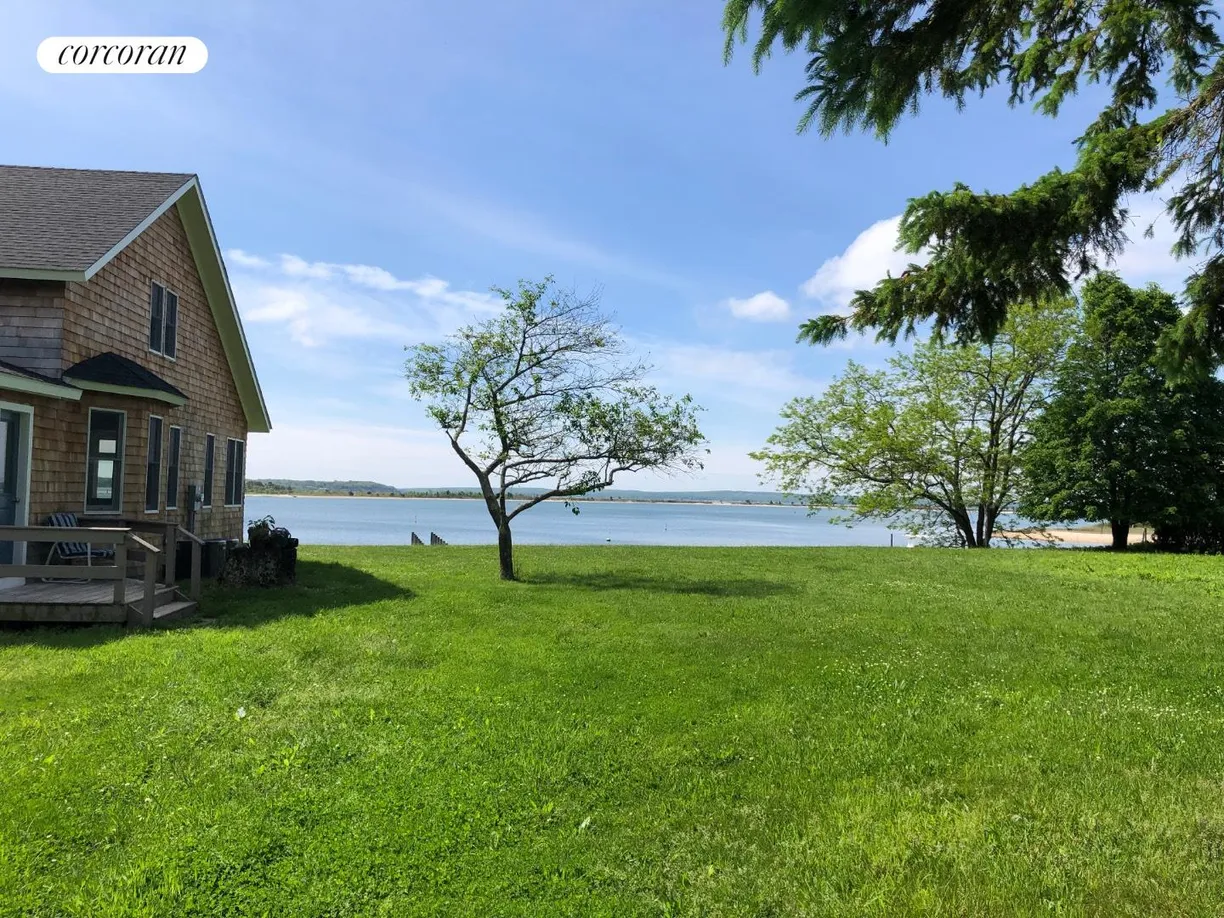 The Hamptons Real Estate | View 63 South Menantic Road | Yard with waterfront