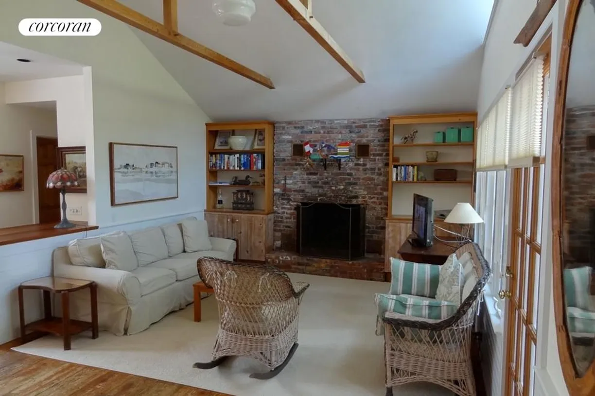 The Hamptons Real Estate | View 63 Treasure Island Drive | living room with fireplace