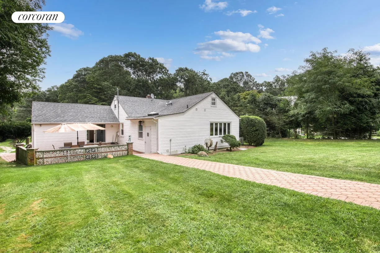 The Hamptons Real Estate | View 65 North Midway Road | Back Yard with patio and pool