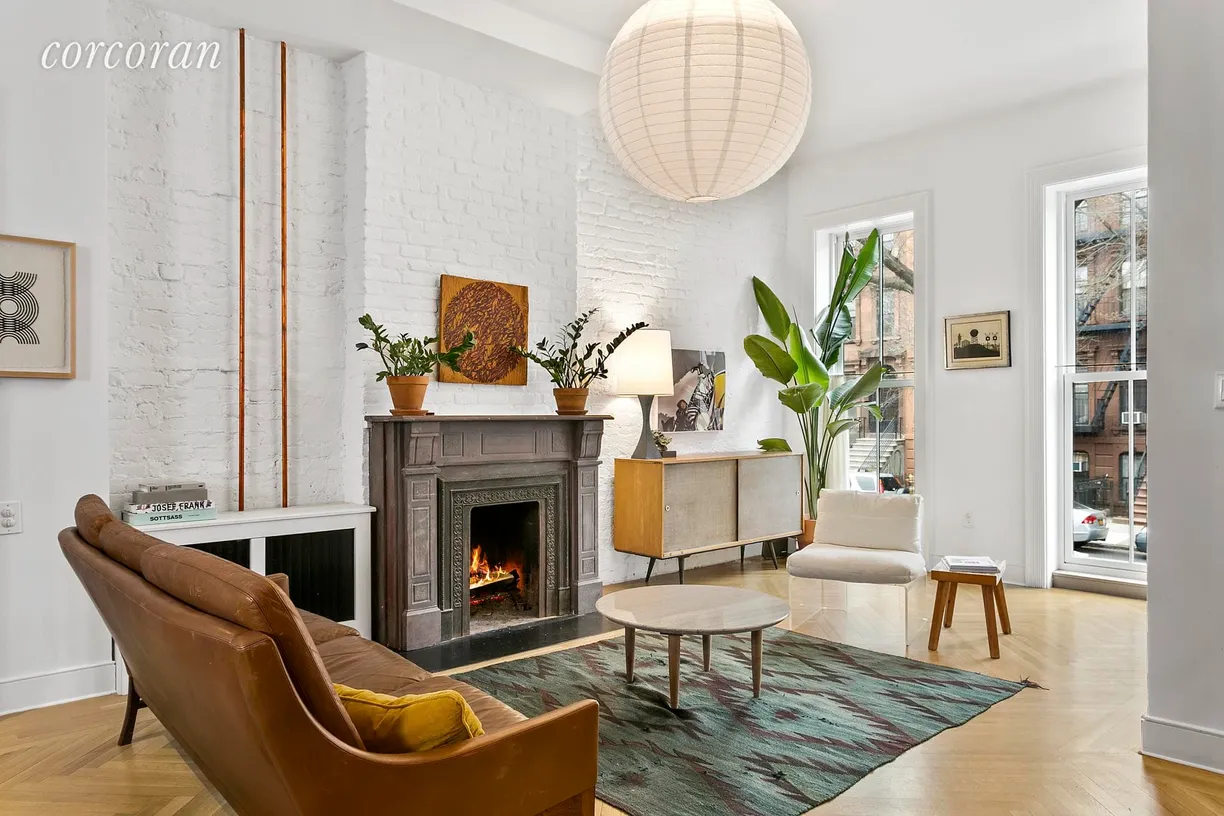 New York City Real Estate | View 44 Monroe Street | Living room with wood burning fireplace!