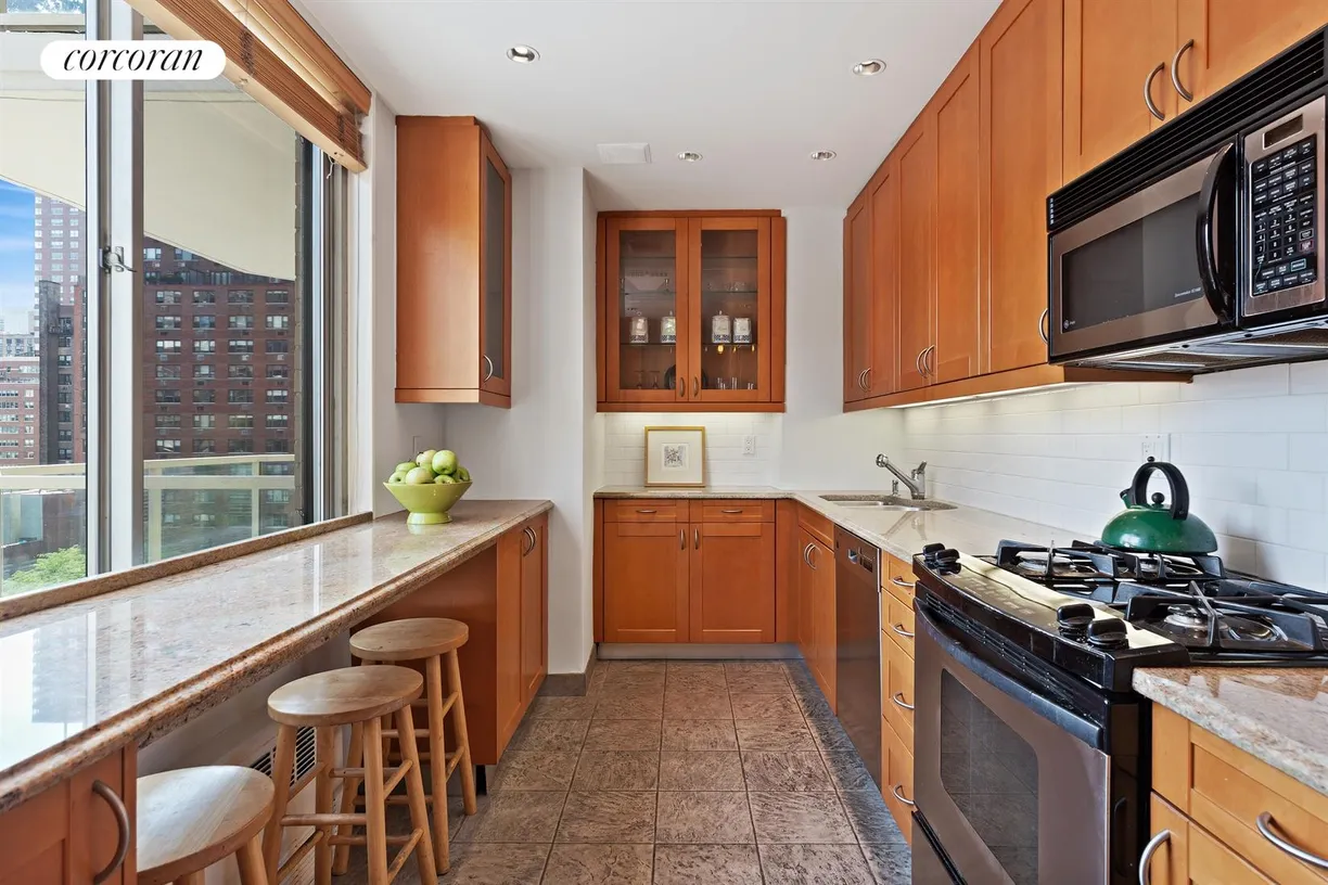 New York City Real Estate | View 300 East 74th Street, 10G | Windowed Kitchen with Dining Bar