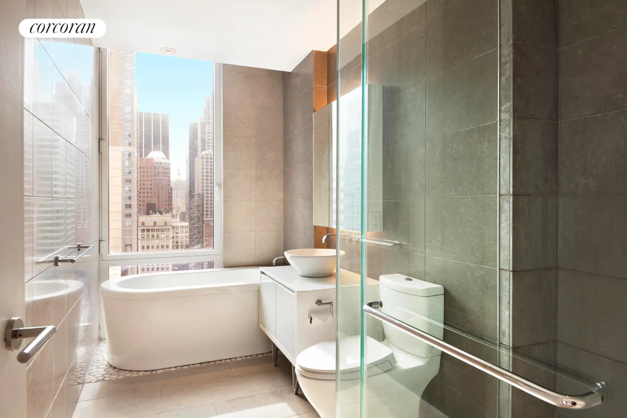 New York City Real Estate | View 247 West 46th Street, 2305 | Deep soaking tub and cobblestone shower
