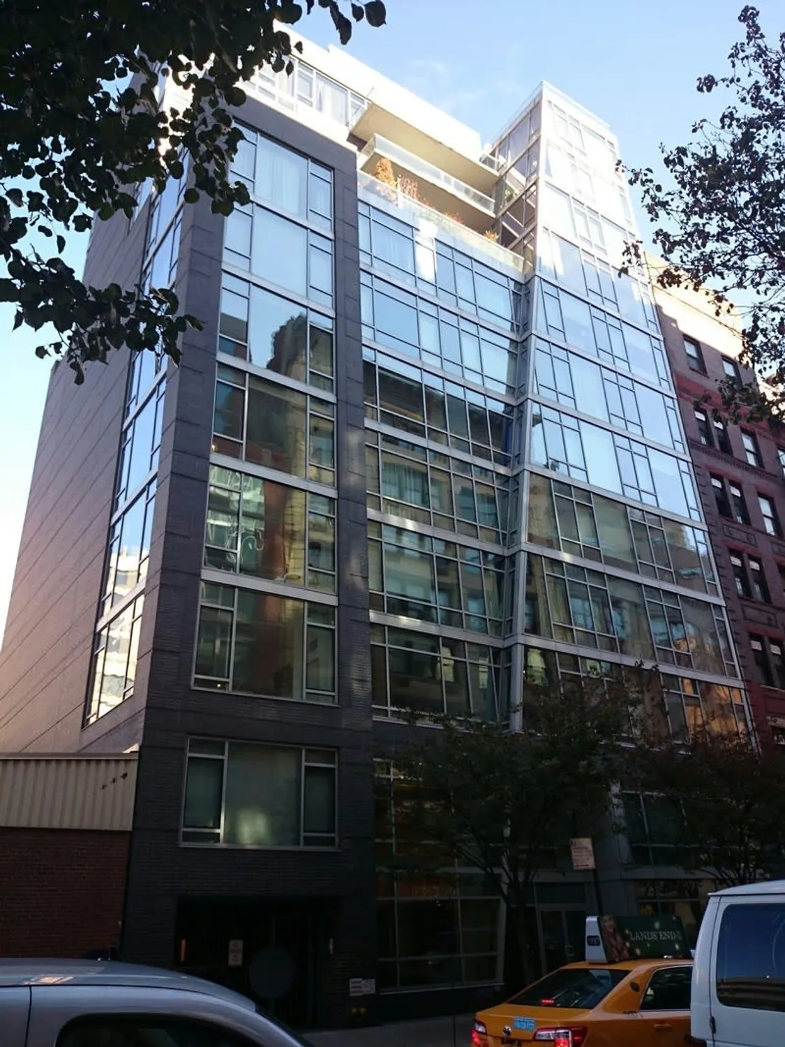 Glass facade on tree-lined 18th Street
