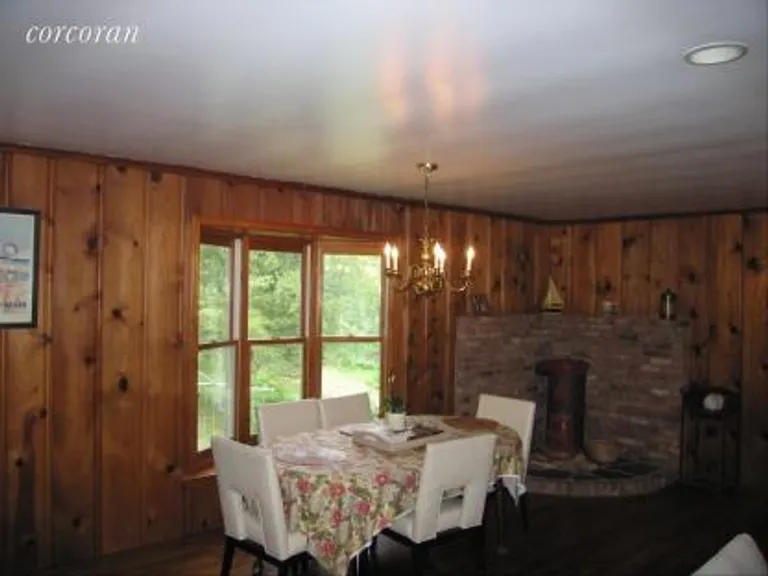 New York City Real Estate | View 26 Rocky Point Road | Dining Area with Wood Stove | View 5