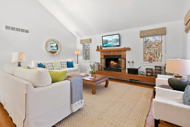 New York City Real Estate | View  | Living room with vaulted ceilings and wood burning fireplace | View 2