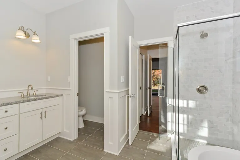 New York City Real Estate | View  | 1st Fl Master suite feat. soaking tub, tiled glass shower, twin vanities, WC, walk-in closets + dressing vanity | View 9