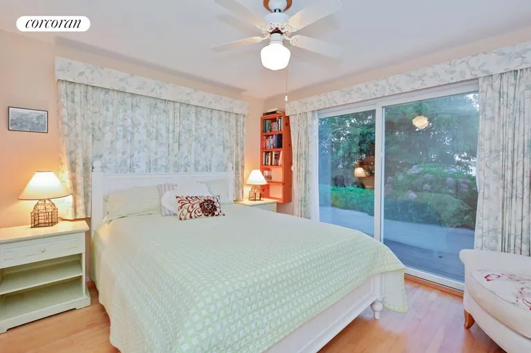 New York City Real Estate | View  | bedroom 2 with lakeviews and sliding door to lakefront deck | View 11