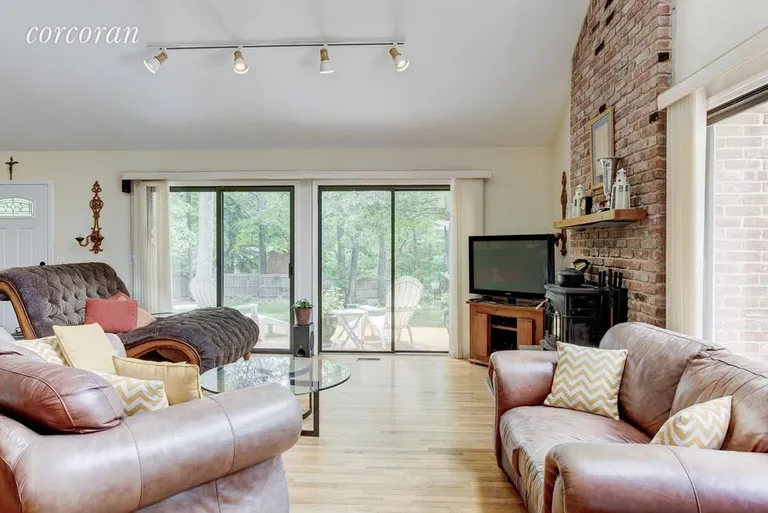 New York City Real Estate | View 48 Dinah Rock Road | living room with fireplace and vaulted ceiling | View 4
