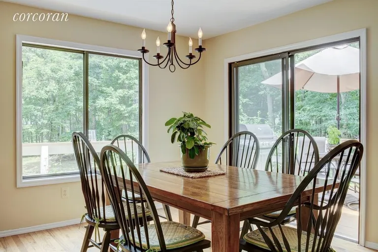 New York City Real Estate | View 48 Dinah Rock Road | dining room with access to deck | View 7