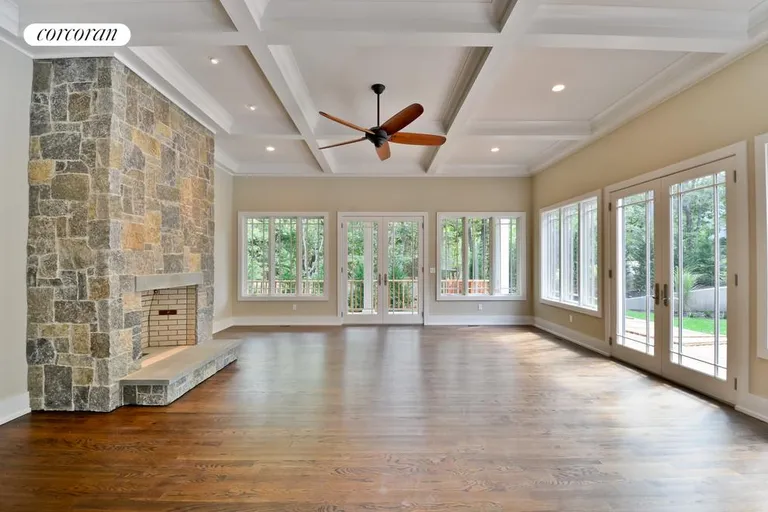 New York City Real Estate | View  | Living room with stone fireplace and french doors | View 3