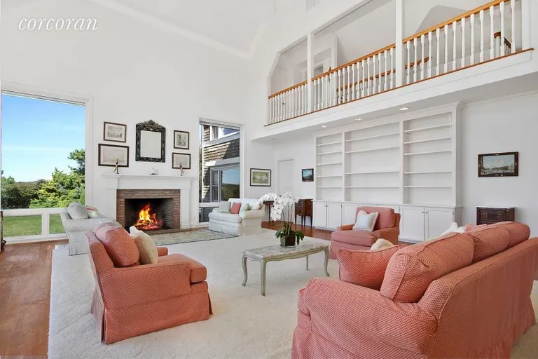 New York City Real Estate | View 24 Chauncey Close | Living Room with Balcony and Fireplace | View 6