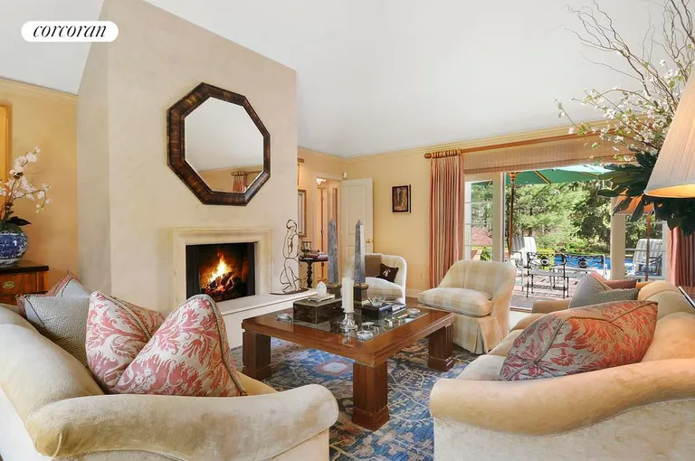 New York City Real Estate | View  | Living room with fireplace opens on to beautiful deck and gardens | View 3