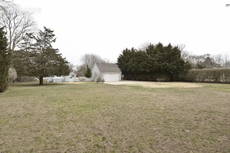 New York City Real Estate | View Quogue | FencedLawn Behind Garage | View 22