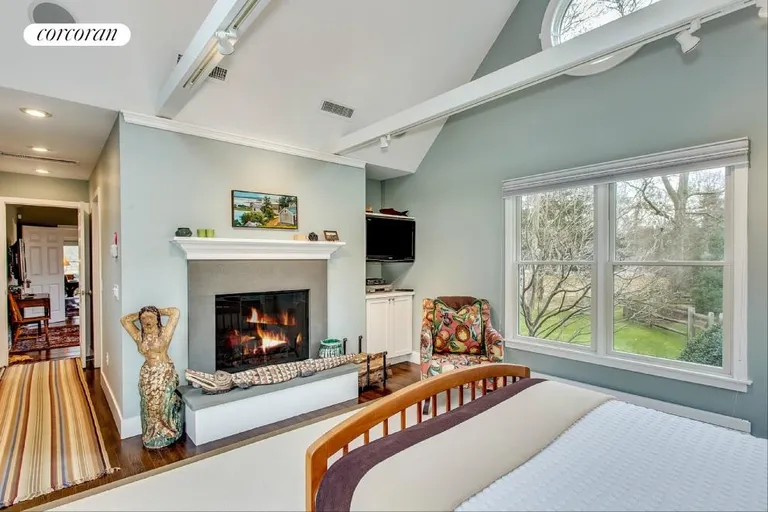 New York City Real Estate | View 104 Old Stone Highway (House & Cottage) | Master Bedroom boasts a fireplace and vaulted ceilings | View 6