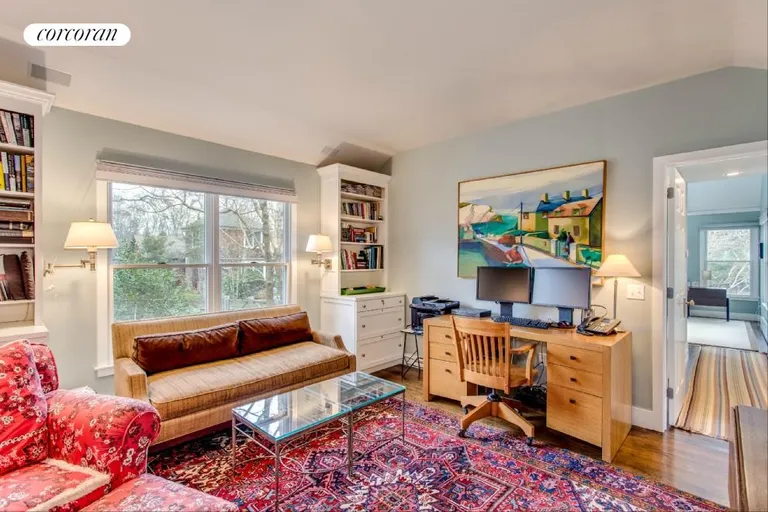 New York City Real Estate | View 104 Old Stone Highway (House & Cottage) | Cozy Den or TV room with the powder room | View 10