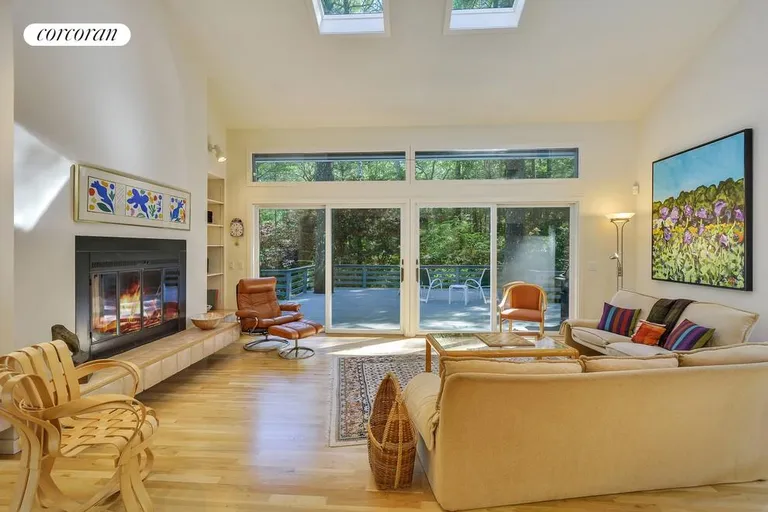 New York City Real Estate | View  | Open plan living room with fireplace and multi-level deck and pool access | View 2