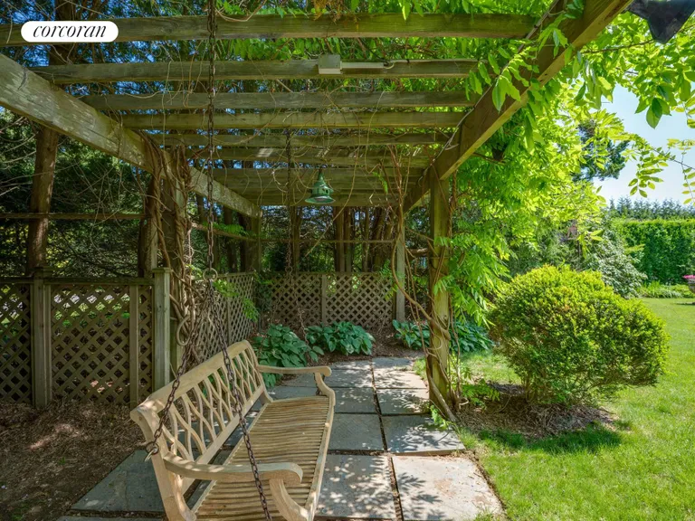 New York City Real Estate | View 146 Westminster Road | with a shady bench | View 16