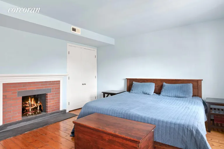 New York City Real Estate | View 132 South Country Road | Master Bedroom with Fireplace | View 13