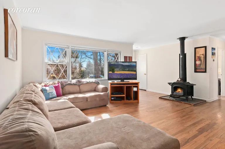 New York City Real Estate | View 13 Cora Court | Light-Filled Living Room with Fireplace | View 2