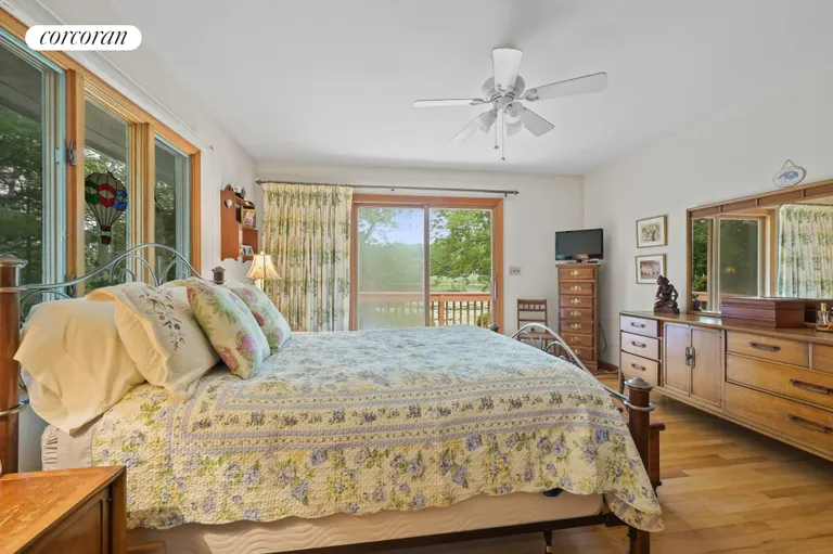 New York City Real Estate | View 191 Big Fresh Pond Road | Primary Bedroom with Sliders to Pond | View 15