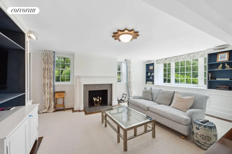 New York City Real Estate | View 120 Edge of Woods Road | Den with Fireplace | View 13