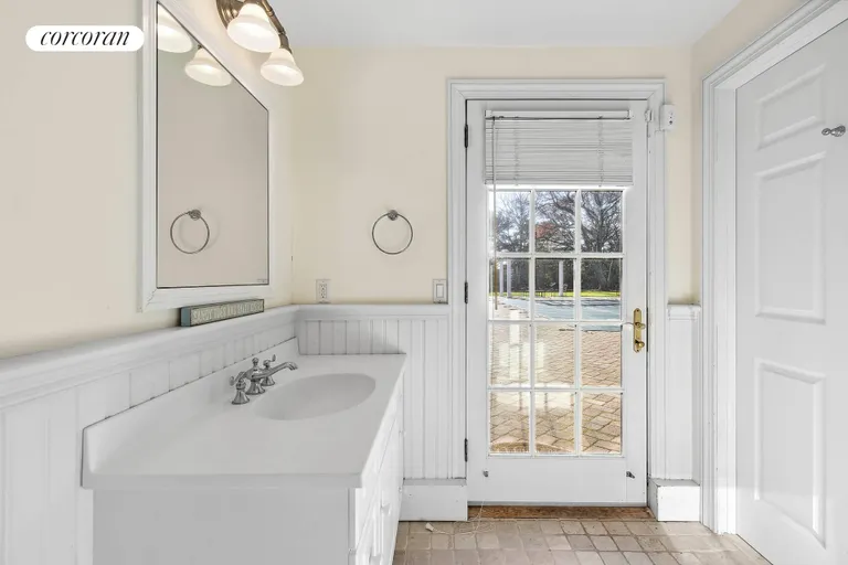 New York City Real Estate | View 15 Bridle Path | Full Pool Bathroom with Access to Garage | View 32