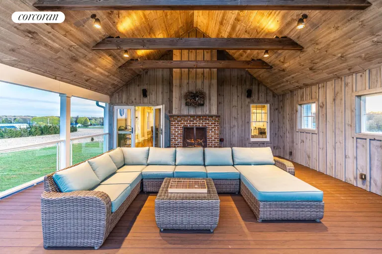 The Hamptons Real Estate | View 1263 Northville Turnpike | Second Story Covered Porch with Gas Fpl | View 16