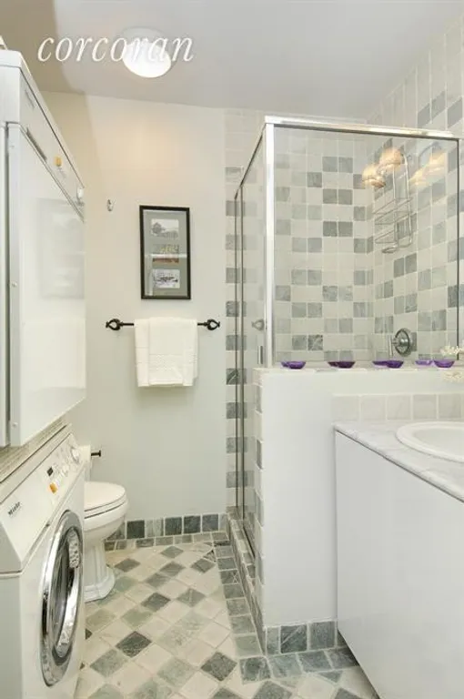 New York City Real Estate | View 22 West 66th Street, 2A | Full white and grey marble bath with washer/dryer | View 10