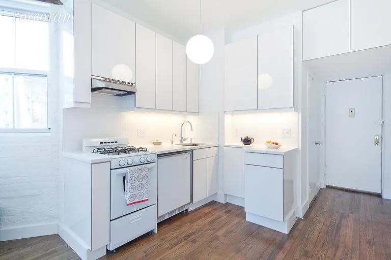 New York City Real Estate | View 92 Horatio Street, 3N | Modern white kitchen with lots of overhead storage | View 2