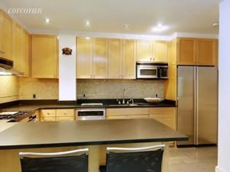 New York City Real Estate | View 126 West 22nd Street, 5S | Stainless appliances + bar | View 3