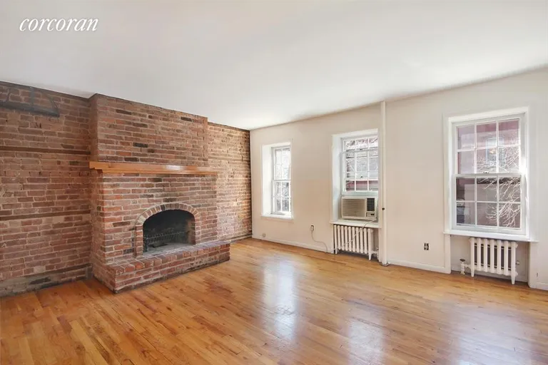 New York City Real Estate | View 251 West 21st Street, 2 | Living Room with beautiful brick walls! | View 2