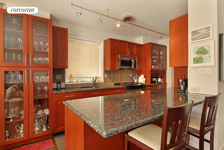 New York City Real Estate | View 130 East 63rd Street, 3E | Renovated open windowed Kitchen with counter | View 3