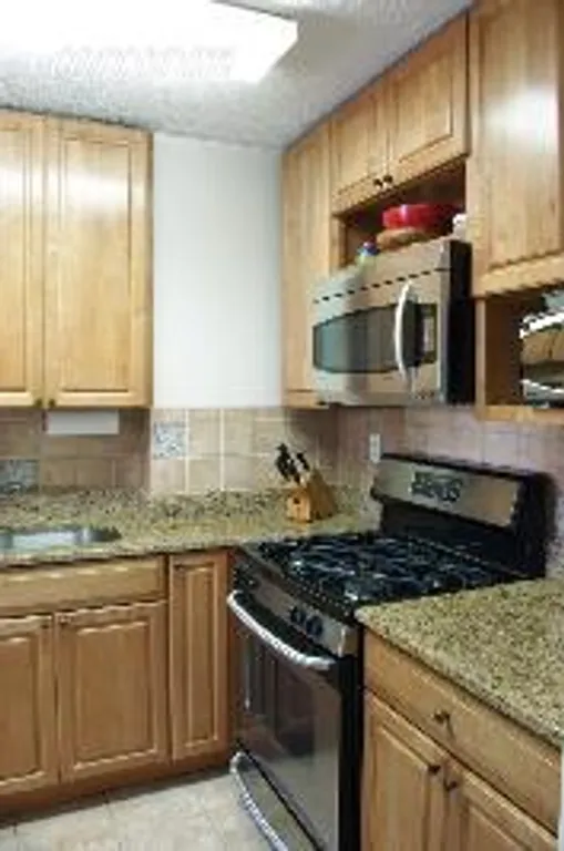 New York City Real Estate | View 345 East 86th Street, 12D | L Shaped Kitchen with Granite Counters | View 3