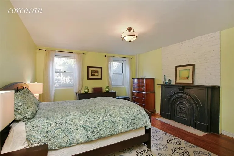 New York City Real Estate | View 86 2nd Place, GRDN | Master bedroom with decorative fireplace | View 5