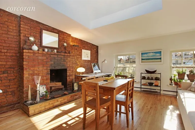 New York City Real Estate | View 356 West 23rd Street, 4B | Woodburning fireplace and exposed brick walls | View 2