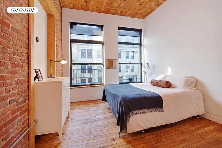 New York City Real Estate | View 138 Broadway, 3C | Sunny Master bedroom- exposed brick & wood ceiling | View 3