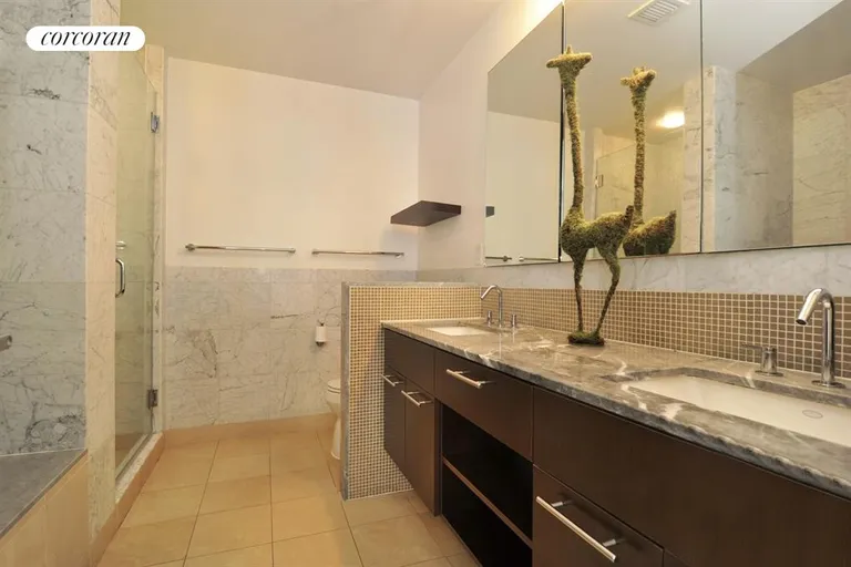 New York City Real Estate | View 261 West 28th Street, 10A | En suite bath with steam shower and soaking tub | View 7