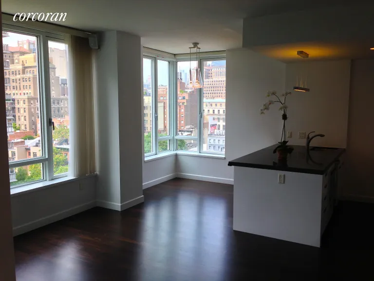 New York City Real Estate | View 261 West 28th Street, 10A | Corner Living Room and Dining area N & W views | View 2