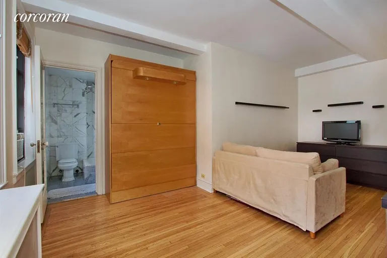 New York City Real Estate | View 457 West 57th Street, 1210 | Living Room with hide-away Murphy bed in Alcove | View 2