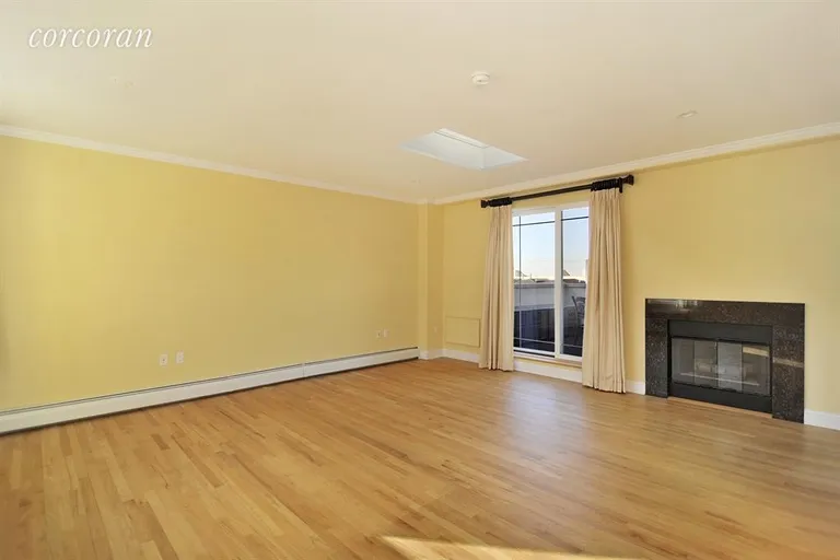 New York City Real Estate | View 1-84 Beach 101st Street, 2C | Living Room with Fireplace and Doors to Terrace | View 2
