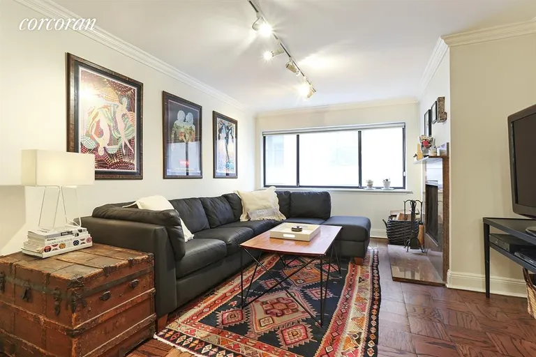 New York City Real Estate | View 7 East 35th Street, 10E | Living Room with a wood burning fireplace! | View 2