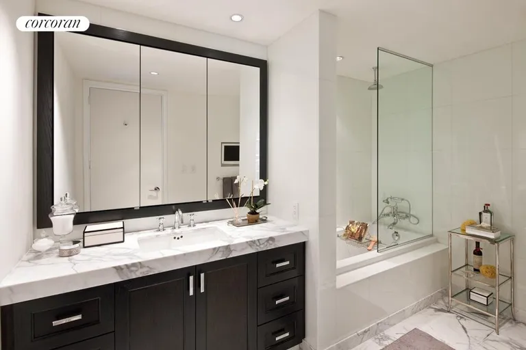 New York City Real Estate | View 333 Rector Place, 1008 | Spacious master bathroom featuring imported Italian marble, separate shower from tub, and intergraded flat panel television. | View 5