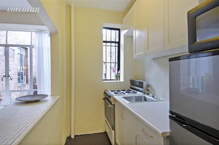 New York City Real Estate | View 255 West 23rd Street, 2AW | Open Windowed Kitchen with Lots of Storage | View 3
