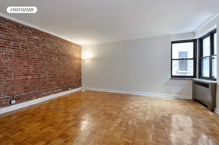 New York City Real Estate | View 736 West 186th Street, 2A | Living room with exposed brick wall. | View 4