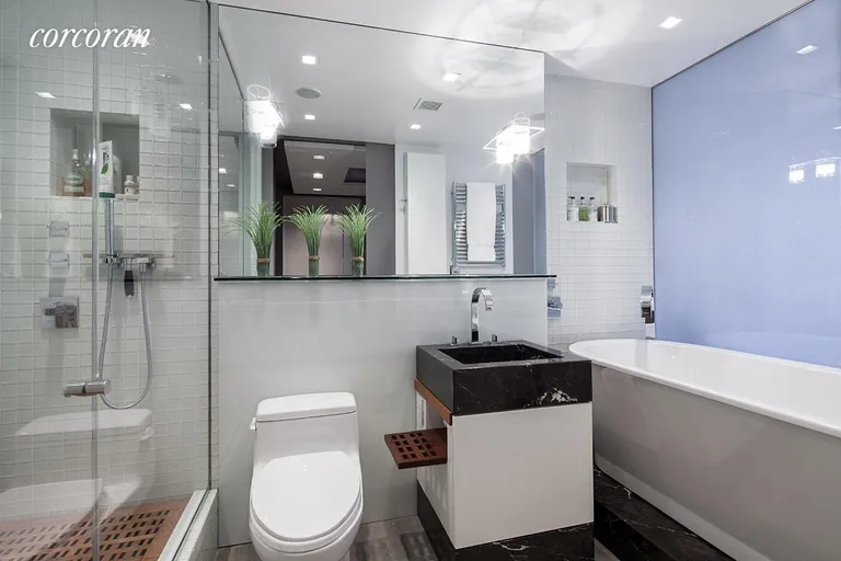 New York City Real Estate | View 1 Irving Place, G19D | Bathroom with steam shower and glass privacy wall | View 5