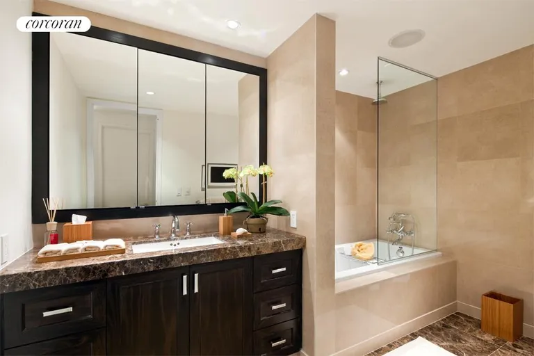 New York City Real Estate | View 333 Rector Place, 1108 | Master bathroom featuring imported Italian marble, separate shower from bath tub, and integrated flat screen TV. | View 4