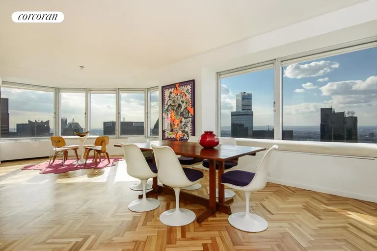 New York City Real Estate | View 150 West 56th Street, 6104 | Dining Room with Hudson River Views | View 2