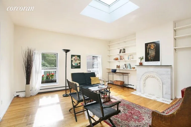 New York City Real Estate | View 110 Clinton Avenue, 3A | Living Room with decorative fireplace & skylight | View 2