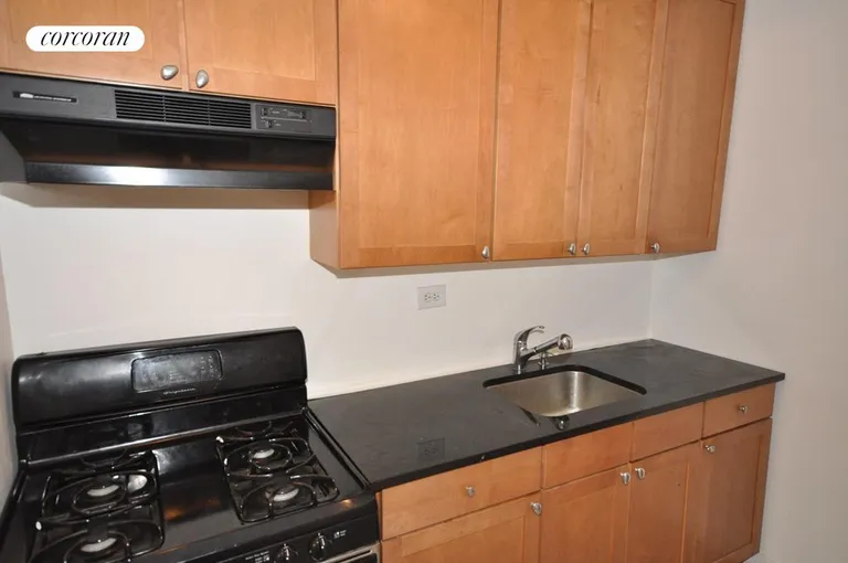 New York City Real Estate | View 191 Willoughby Street, 2D | Rich wood Kitchen cabinets & black stone counters | View 9