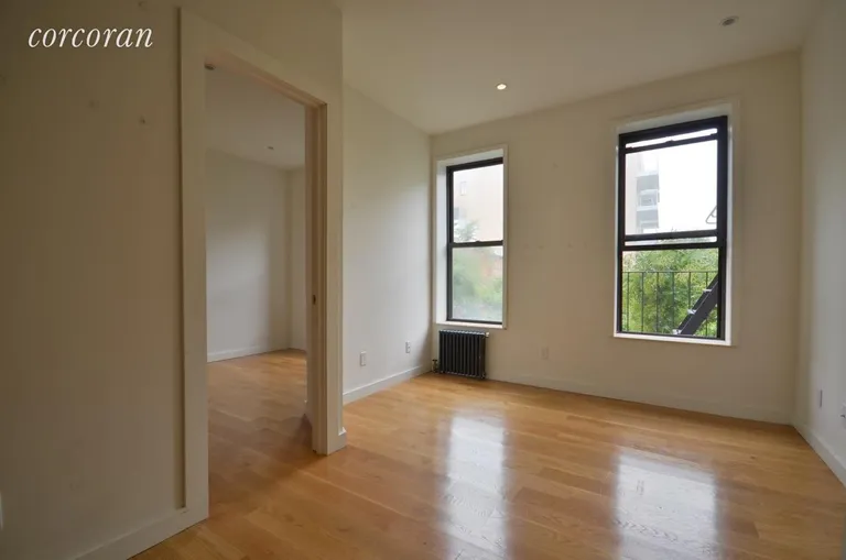 New York City Real Estate | View 206 Thompson Street, 11 | Living Room with Treetop View! | View 2